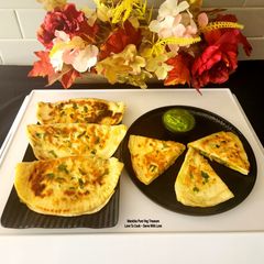 A picture of Bolani - Afghani Breakfast - Flatbread Stuffed With Potatoes, Spring Onions, Cilantro And Spices.