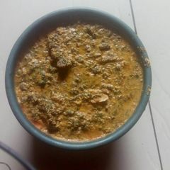 A picture of Egusi soup with vegetable.