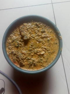 A picture of Egusi soup with vegetable.