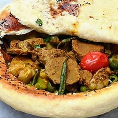 A picture of Beef Stew Covered With Bread.