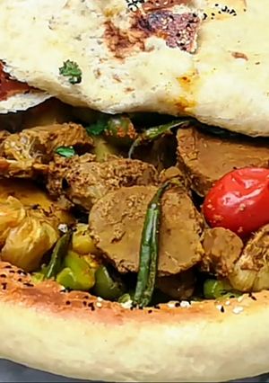 A picture of Beef Stew Covered With Bread.