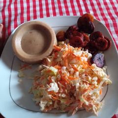 A picture of Moimoi,coleslaw and fried plantain.