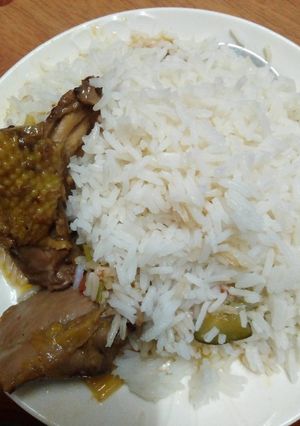 A picture of Stewed chicken served with rice.