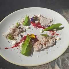 A picture of Paperbark smoked crocodile entree with wattleseed beetroot puree.