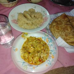 Pori with halwa and sour potatoes curry A picture of Pori with halwa and sour potatoes curry.