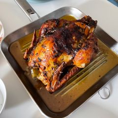 A picture of Garlic Butter Roast Chicken with herbs.