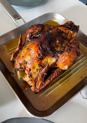 A picture of Garlic Butter Roast Chicken with herbs.