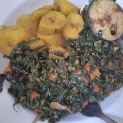 A picture of Unripe plantain and vegetable sauce with fish.