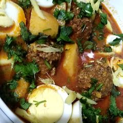 A picture of Alu kofta curry with eggs..