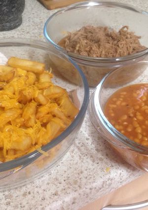 A picture of Pulled BBQ pork with Beans and Cheesy Chips 💜.