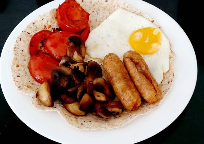 My open Wrap Breakfast of Garlic mushrooms, Sausage, Egg + Tomato