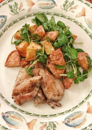 A picture of Sous vide quail breasts with warm potato and watercress salad.