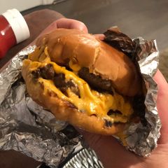 A picture of A gooey, naughty, cheeseburger.