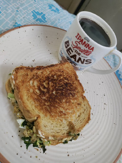 A picture of Tuna egg kale avocado sandwich.