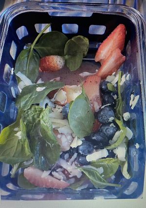 A picture of Strawberry, blueberries spinach salad.
