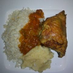A picture of Tasty grilled chicken with rice and mashed potatoes.