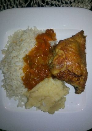 A picture of Tasty grilled chicken with rice and mashed potatoes.