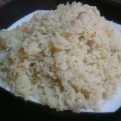 A picture of Basmati rice with onions and dill.