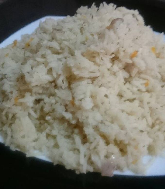 A picture of Basmati rice with onions and dill.