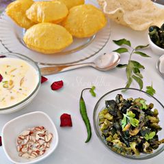 Turiya patra with poori and basundi A picture of Turiya patra with poori and basundi.