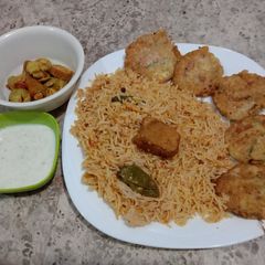 A picture of Chicken pulaw and aalo cutles.