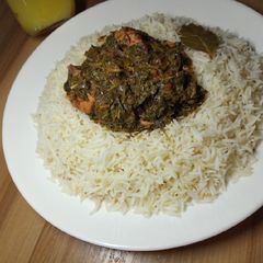 A picture of White rice with chicken vegetable soup.