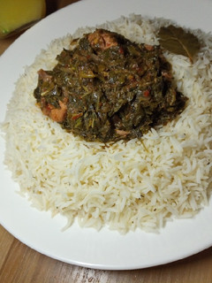 A picture of White rice with chicken vegetable soup.