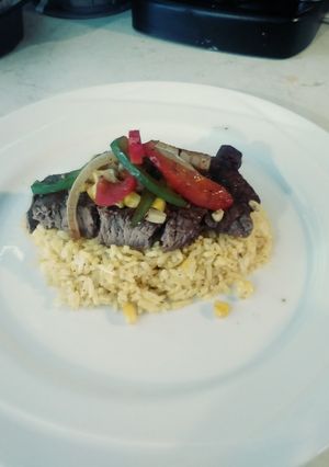 A picture of Steak & Turmeric Rice with Sauteed Corn, Onions & Pepprs.