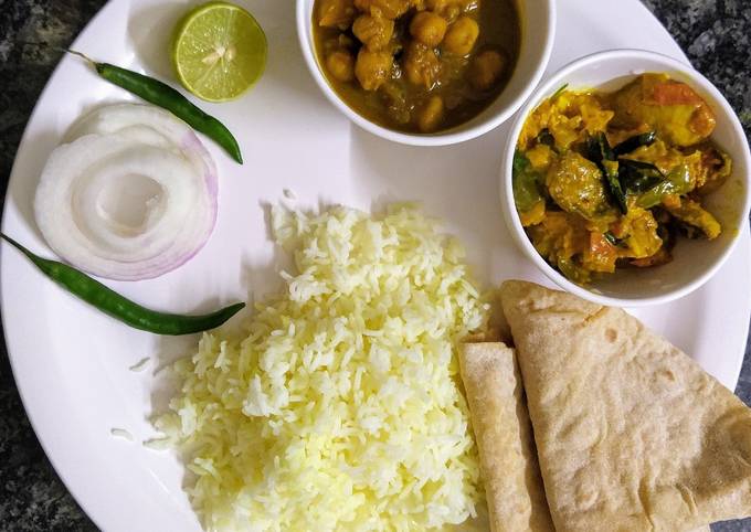 Veg lunch thali with rice, chhole, mushroom masala and chapati