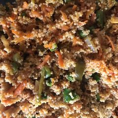 A picture of Cous cous cooked salad with tikka chicken.