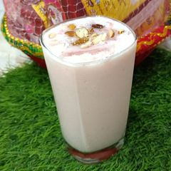 A picture of Curd Lassi with dry fruit.