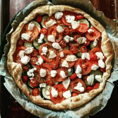 A picture of Tart with zucchini, tomatoes and goat cheese.