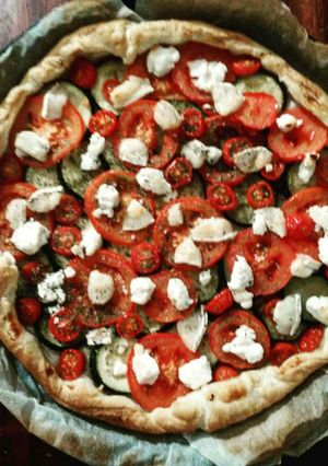 A picture of Tart with zucchini, tomatoes and goat cheese.