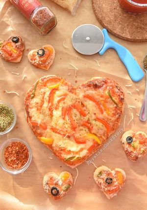A picture of Heart shaped Veg pizza.