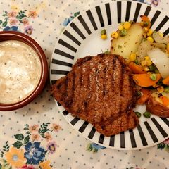 A picture of Beef steak with creamy peppercorn sauce.