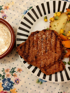 A picture of Beef steak with creamy peppercorn sauce.