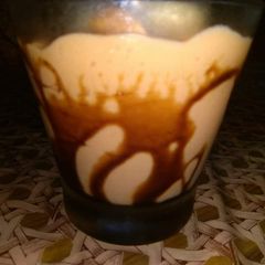 A picture of Mango shake with chocolate syrup.