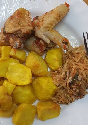 A picture of Roasted potatoes served with kienyenji chicken and cabbage.
