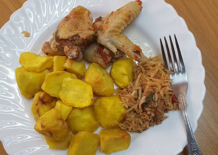 Roasted potatoes served with kienyenji chicken and cabbage