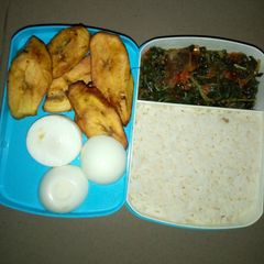 White rice and vegetable sauce with plantain and egg A picture of White rice and vegetable sauce with plantain and egg.