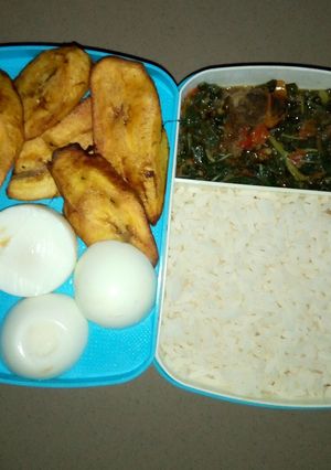 A picture of White rice and vegetable sauce with plantain and egg.