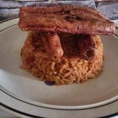 A picture of Jollof rice with sausage.