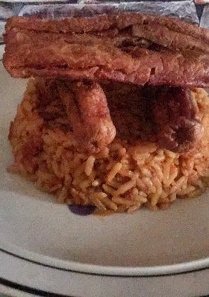 A picture of Jollof rice with sausage.