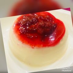 A picture of Whosayna’s Panna cotta with Strawberry Sauce.