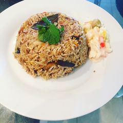 A picture of Vangi bath (brinjal rice).