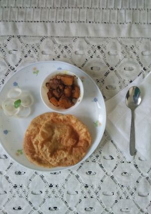 A picture of Aachari pumpkin vegetable with whole wheat puri.