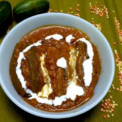 A picture of Potoler dolma pointed gourd with spicy filling.