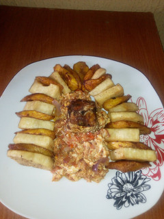 A picture of Fried Yam/Ripe plantain,egg sauce and fried mackerel fish.
