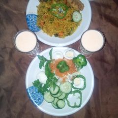A picture of Fried rice with victoria chicken and salad.