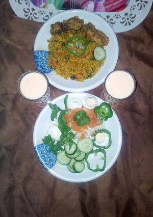 A picture of Fried rice with victoria chicken and salad.